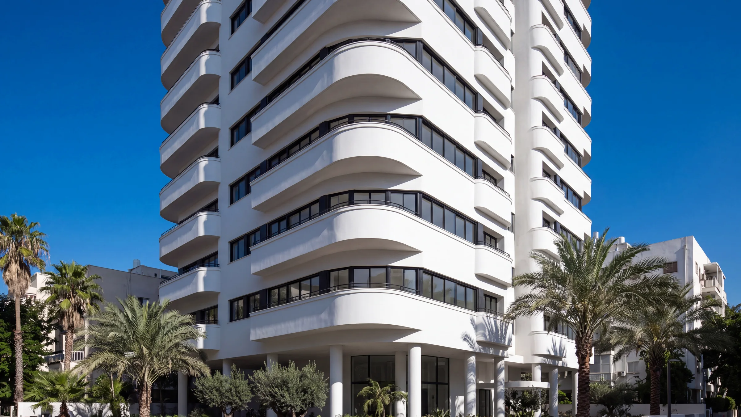 ALBA Residences seen from Rothschild Boulevard, a white tower with curved balconies