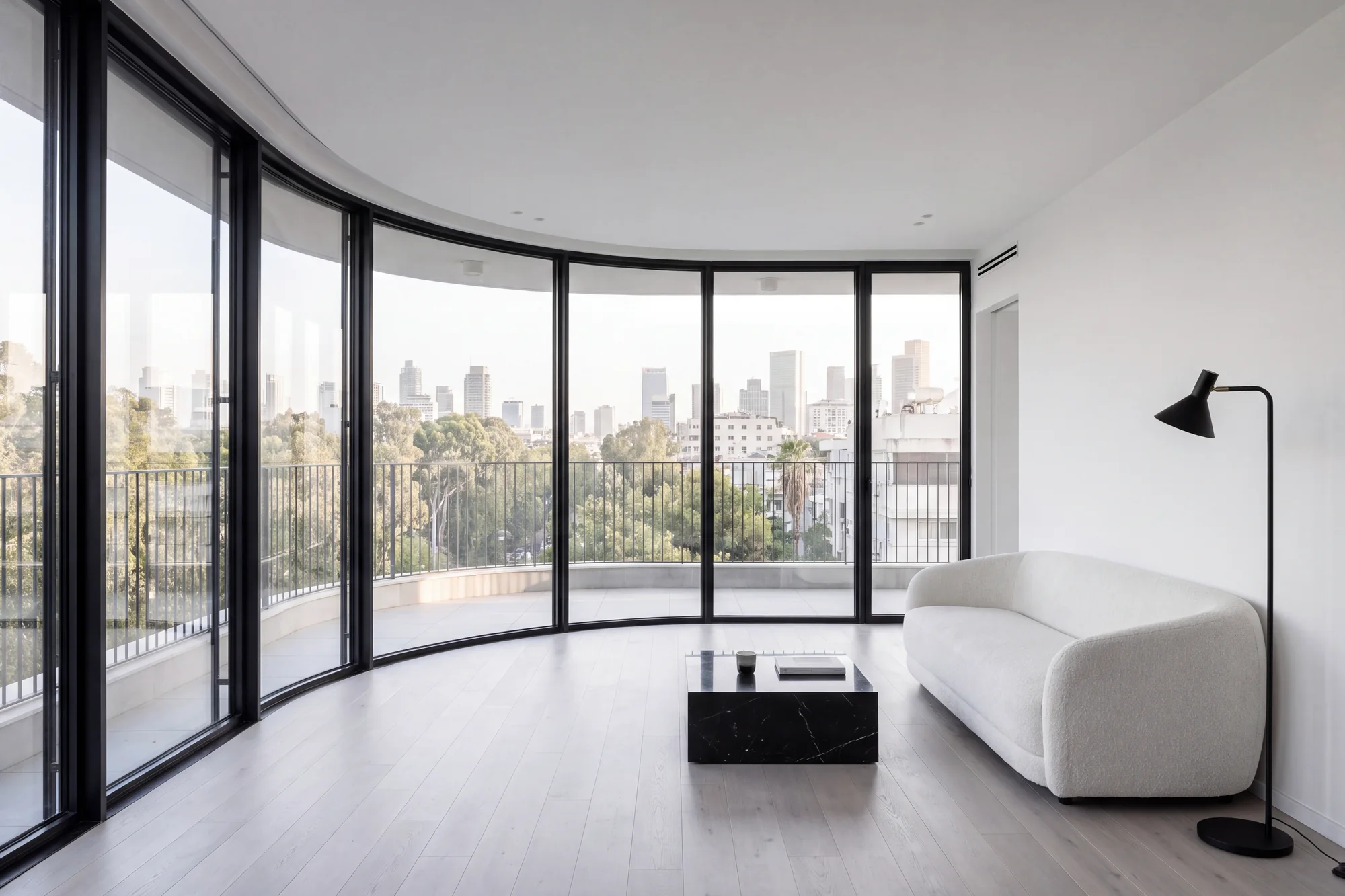 Living room of a two bedroom residence opening onto its curved terrace