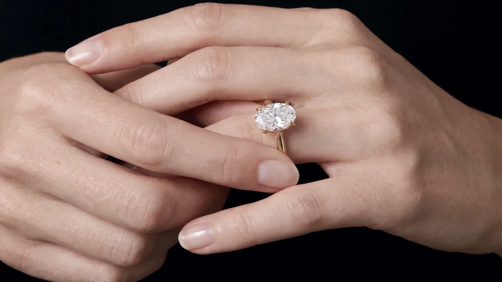 An oval diamond solitaire on a hand