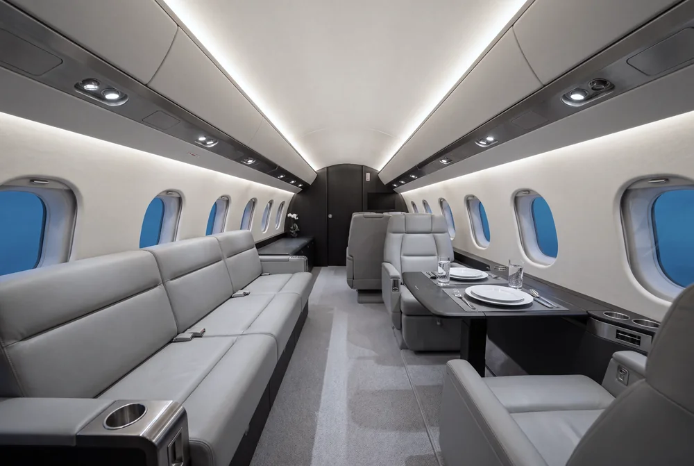 Super-midsize jet cabin with divan and a set table