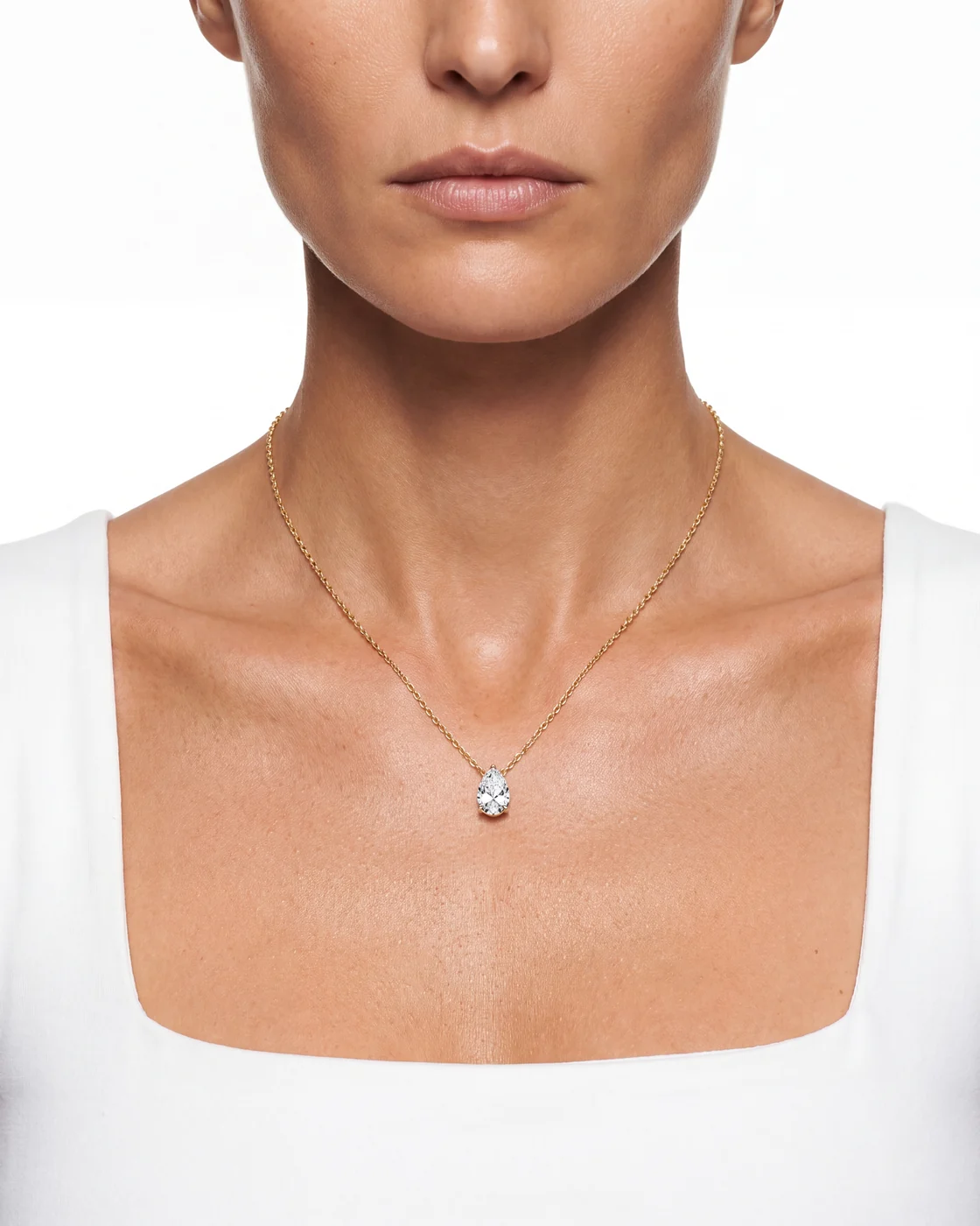 The Lune pendant worn at the neckline